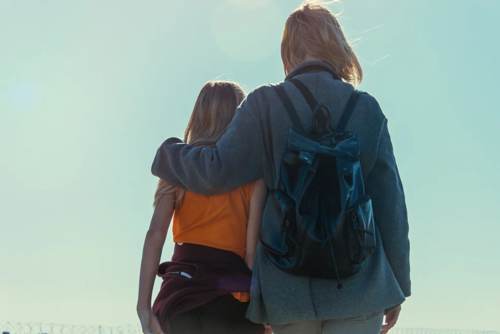 A mom hiking with her daughter.