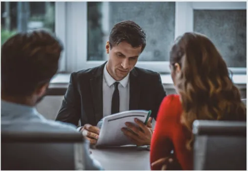 An attorney meeting with a couple.